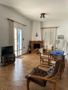 a living room with a couch and a tv at Molly’s Home in Víssa