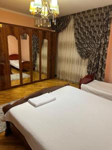 a bedroom with two beds and a large mirror at Darhan in Tashkent