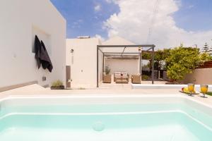 a swimming pool in the backyard of a house at Van Loui's II Place in Áyioi +23 photos