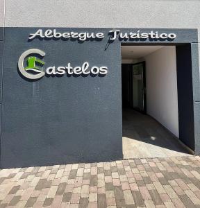 a building with a sign on the side of it at ALBERGUE CASTELOS VILALBA in Villalba