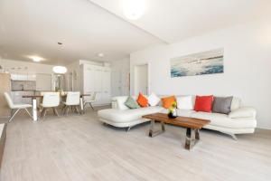 a living room with a couch and a table at Apartments Tony in Mali Lošinj