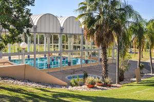 ein großes Gebäude mit einem Pool und Palmen in der Unterkunft Mina's luxury suite - panoramic sea view- קיסריה in Caesarea
