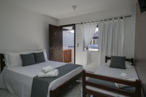 Postel nebo postele na pokoji v ubytování Hotel Pousada Porto da Lua