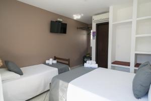 Postel nebo postele na pokoji v ubytování Hotel Pousada Porto da Lua