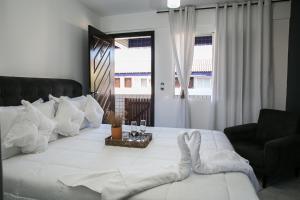 Postel nebo postele na pokoji v ubytování Hotel Pousada Porto da Lua