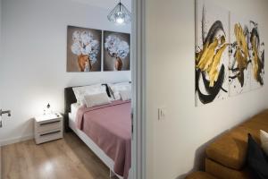 a bedroom with a bed and some pictures on the wall at Apartment Palazzo, Zagreb town centre in Zagreb