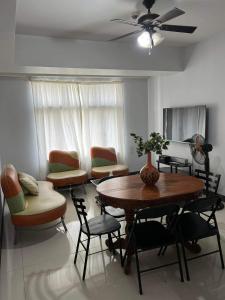 a living room with a table and chairs at Spacious 3BR Manhattan Parkview Tower 2 in Manila