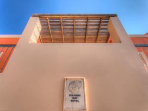 a sign on the side of a building with a window at Fiscardo Bay Hotel in Fiskardo