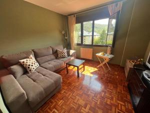 a living room with a couch and a table at VILLA CARMEN. coqueto apartamento con piscina y garaje in Ezcaray