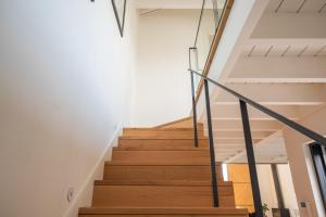 a staircase in a house with white walls and wooden floors at Loft in Porto in Porto