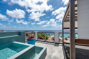 a view of the ocean from the balcony of a house at Bloozz resort Bonaire in Kralendijk