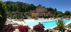 a house with a swimming pool in front of a house at Un petit paradis en Provence in Fréjus