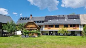a house with solar panels on the roof at Pr `Agotnik Apartments & Rooms Bohinj in Bohinj