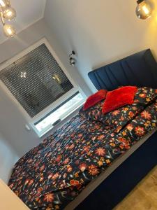 a bed in a small room with a window at Apartament Nowoczesny w Centrum Torunia/podziemny parking i winda in Toruń