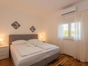 a white bed in a room with a window at Amazing Villa Grande with swimming pool in Sveti Petar +42 photos