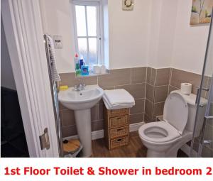 a small bathroom with a toilet and a sink at NightRest Homes 6 Bedroom House- Smart TV In each Room - Parking - Wifi -Milton Keynes in Milton Keynes +32 photos