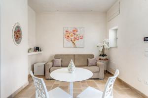 a living room with a couch and a table and chairs at Ostuni Dimore Aurea in Ostuni +45 photos