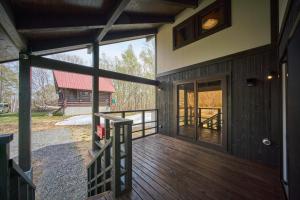 a large deck with a view of a barn at Slow House Niseko in Niseko