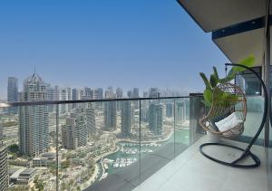 a balcony with a view of a city at Marina Gate Modern & Unique 1 Bed by AirDHP in Dubai