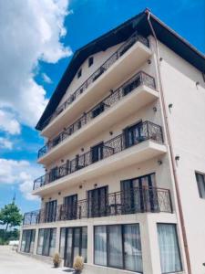 a tall building with balconies on the side of it at Apartamente 9 - Naomi in Baile Felix