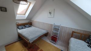 a bedroom with two beds and a window at Szara Czapla in Borowy Młyn