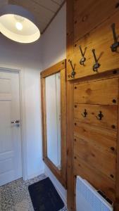 a room with a wooden wall with a mirror at Szara Czapla in Borowy Młyn +44 photos