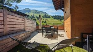 a patio with chairs and a table with a view at Les Chalets de l'Adret in Le Grand-Bornand
