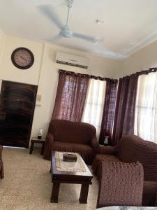 a living room with two couches and a coffee table at Downtown Apartment in Bayt Sāḩūr