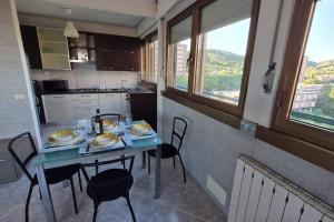a kitchen with a table with plates of food on it at Prospettiva Mare Apartament in Piombino +14 photos