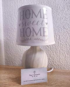 a lamp with a home sweet home sign on a table at Maya's Apartments in Kruševo