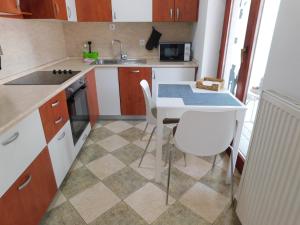a small kitchen with a table and a sink at Apartment Stella in Koper