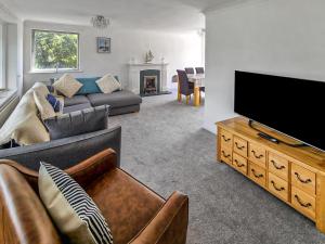 a living room with a couch and a flat screen tv at Solent View in Seaview