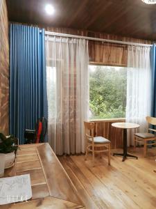 a room with a table and chairs and a window at Tuyet's hostel in Ninh Binh