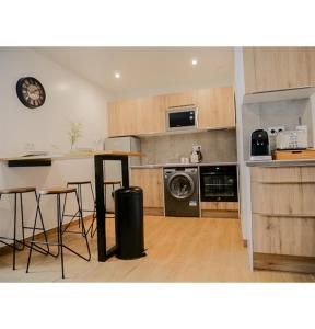a kitchen with a counter and a table and a stove at #L'Estere WiFi-Netflix-Clim in Eauze +7 photos