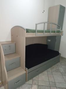 a bunk bed in a room with a mirror at Casa vacanze completa di tutto e anche di più in Livorno