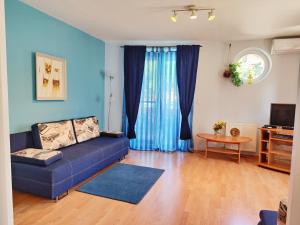 ヘーヴィーズにあるSpirit of Héviz Apartmentのリビングルーム(青いソファ、テーブル付)