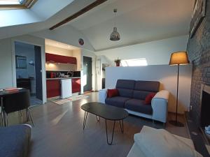 sala de estar con sofá y mesa en Les Suites Angevines, en Angers