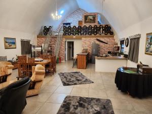 a large living room with a table and chairs at Arch Cabins Self Catering Homes Storms River in Stormsrivier