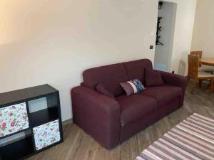 a brown couch in a living room with a television at FONTANA’S HOUSE RELAX 13A in Valbravenna