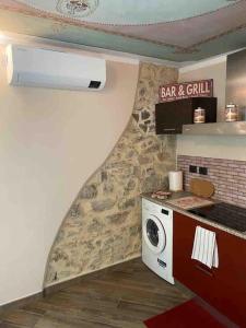 a kitchen with a stove and a microwave at FONTANA’S HOUSE RELAX 13A in Valbravenna