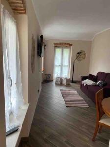 a living room with a couch and a window at FONTANA’S HOUSE RELAX 13A in Valbravenna