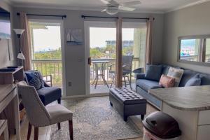 a living room with a couch and a table at Sea Cabin 306-A in Isle of Palms