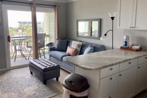 a living room with a couch and a table at Sea Cabin 306-A in Isle of Palms