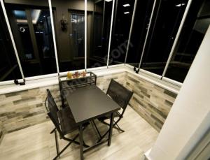 a black table and chairs on a balcony at MAX 3+1 in Istanbul