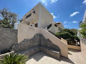a building with stairs leading up to a house at Asterias Studios in Adamantas
