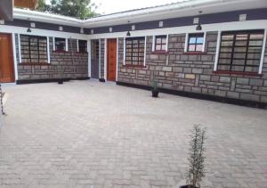 duży ceglany budynek z dużym patio w obiekcie Aster Suites Kisumu w mieście Awasi