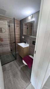 a small bathroom with a sink and a shower at New Large STUDIO flat in Tel Aviv 47 in Tel Aviv