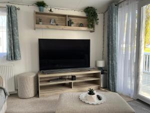 a living room with a flat screen tv on a stand at Billing Aquadrome Luxury 2022 Static Caravan Sleeps 6 in Great Billing