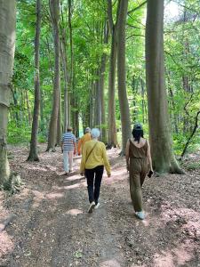 a group of people walking down a path in the woods at The Green Mile in Aalter