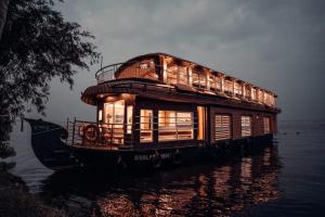 a house boat floating in the water at Venice Premium Houseboats Alleppey in Alleppey
